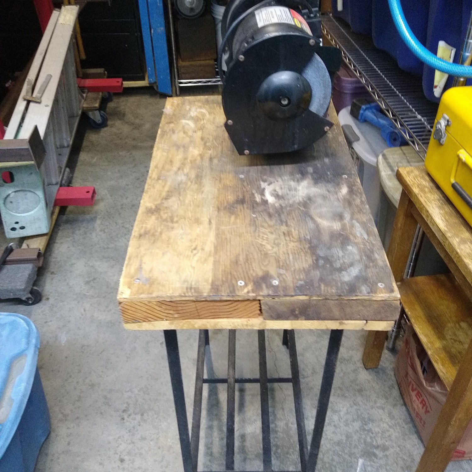 Bench grinder mounted on small table.